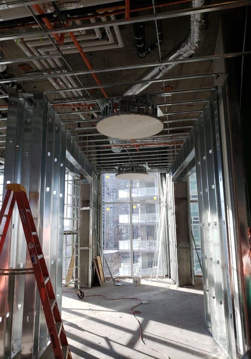 Circular drywall bulkheads framed in a corridor