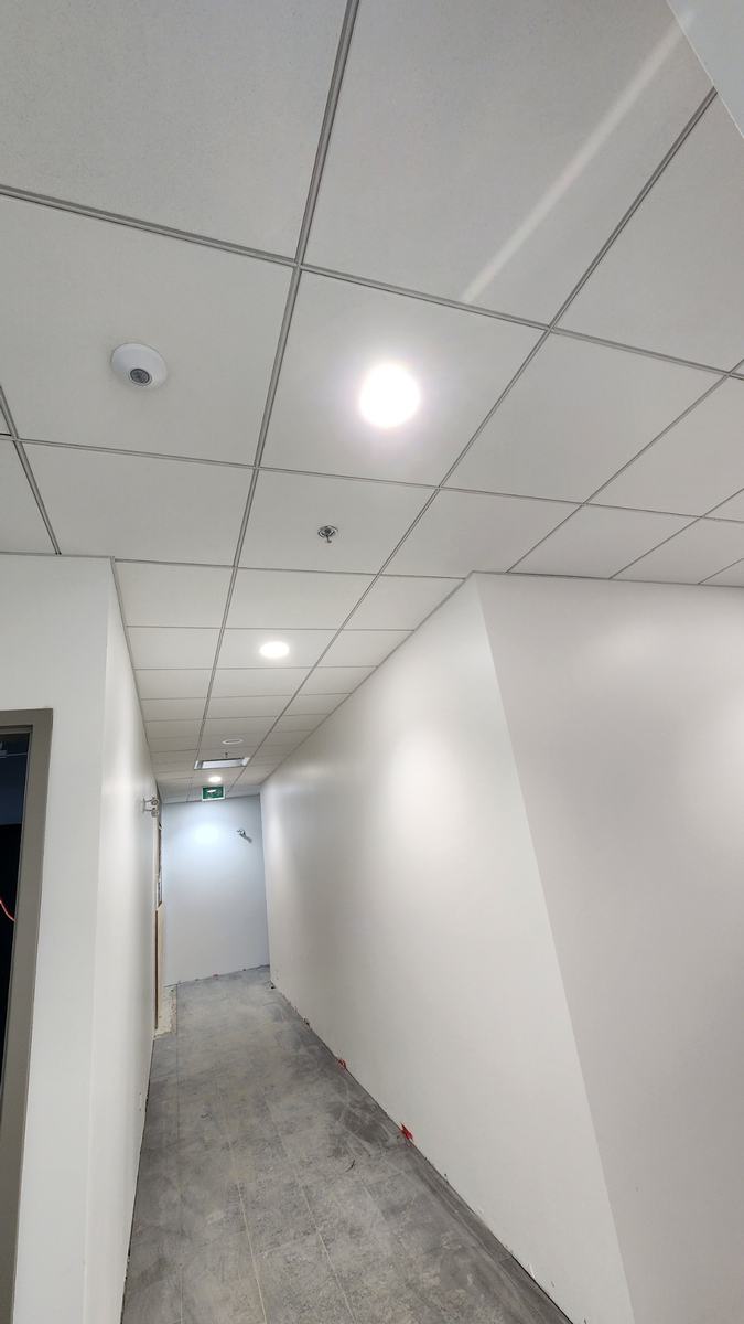 Finished corridor with acoustic ceiling tile and painted walls