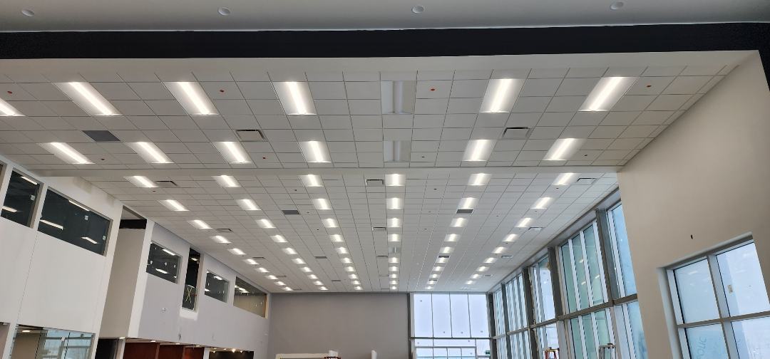 Completed office ceiling grid with a regular pattern of light fixtures