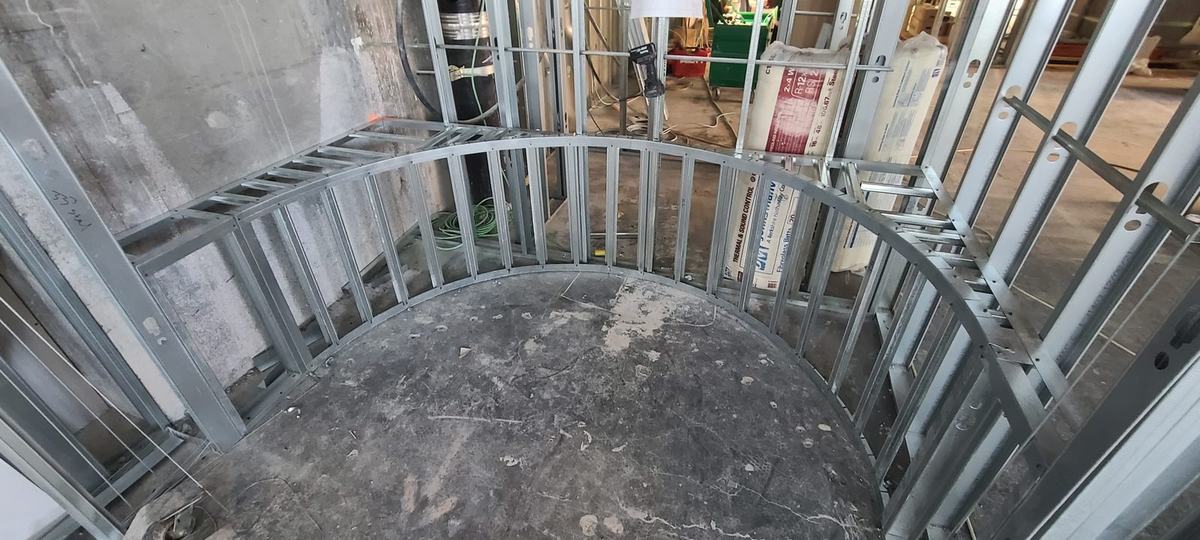 Curved steel stud wall framed on a concrete floor